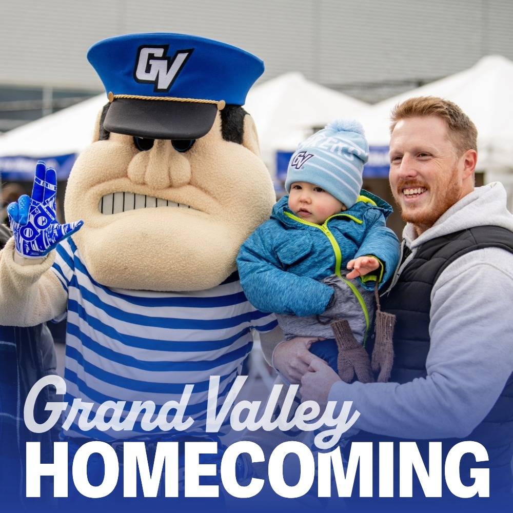 Laker family smiles wearing with Louie at Homecoming